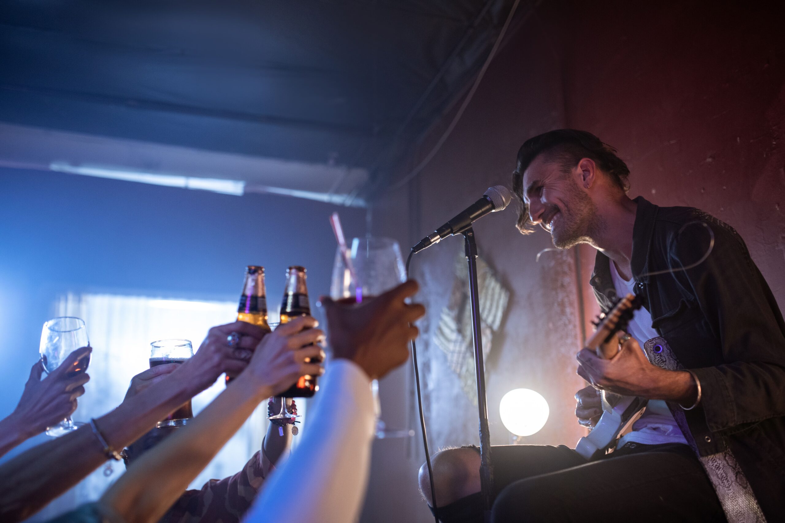 Friends singing karaoke together at a party