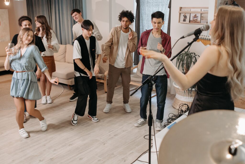 Woman singing an upbeat karaoke anthem to a cheering crowd
